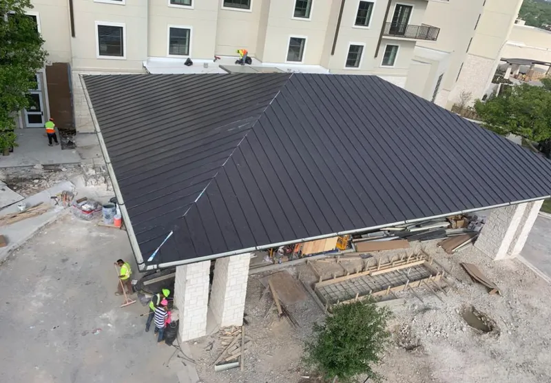 Metal roofing installation team working on a commercial building in Camas